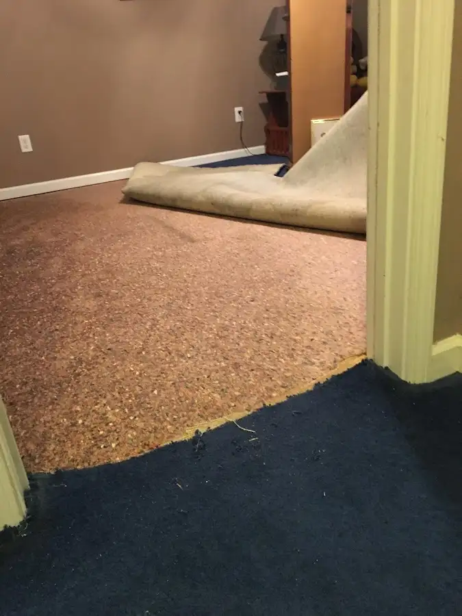 Carpet pad removal revealing water damage during Drying & Dehumidification in Fairfield Plantation